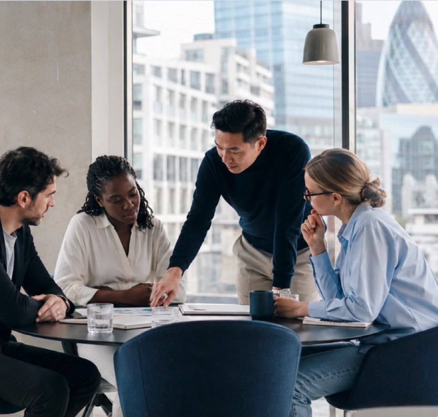 Diverse business team discussing documents around a table in a modern office